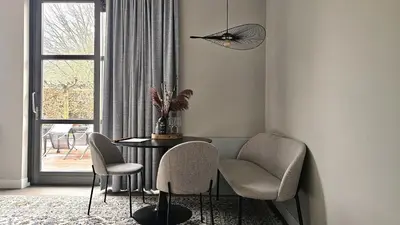 a dining room with a table and chairs and a window at Guest Room Utrecht in Utrecht