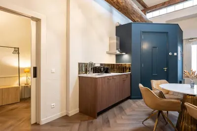 a kitchen with a blue cabinet and a table at Grapèlli Boutique Hotel in Alkmaar