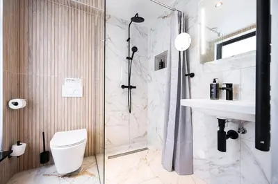 a bathroom with a shower and a toilet and a sink at Limehome Amsterdam Leidsekruisstraat in Amsterdam