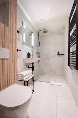 a bathroom with a toilet and a sink and a shower at Limehome Amsterdam Leidsekruisstraat in Amsterdam
