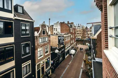 a view of a street in a city with buildings at Limehome Amsterdam Leidsekruisstraat in Amsterdam