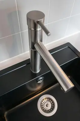 a sink with a faucet on top of it at Aparthotel North Spacious Suite for 6 Guests in Amsterdam