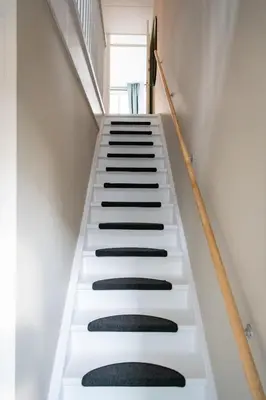 a staircase with black and white risers in a house at Aparthotel North Spacious Suite for 6 Guests in Amsterdam