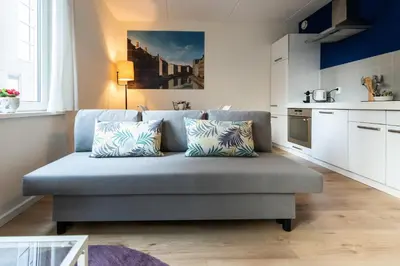 a living room with a couch in a kitchen at Aparthotel North Spacious Suite for 6 Guests in Amsterdam