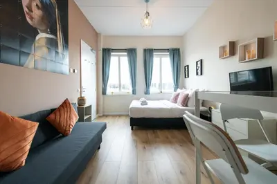a living room with a couch and a bed at Aparthotel North Spacious Studio for two in Amsterdam