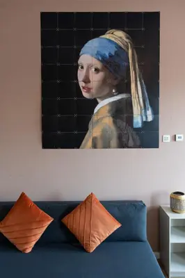 a painting of a woman with a head scarf at Aparthotel North Spacious Studio for two in Amsterdam