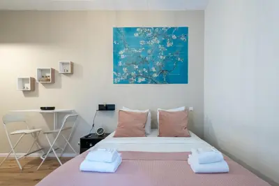 a bedroom with a bed with two towels on it at Aparthotel North Studio With Patio For 2 in Amsterdam