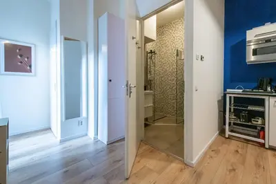 a bathroom with a walk in shower and a glass door at Aparthotel North Studio With Patio For 2 in Amsterdam