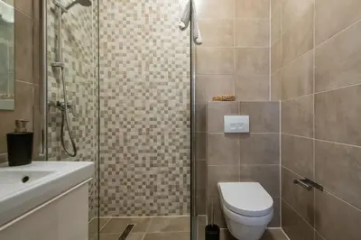 a bathroom with a shower and a toilet and a sink at Aparthotel North Studio With Patio For 2 in Amsterdam
