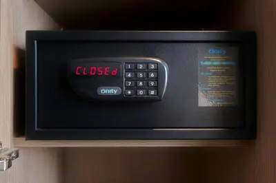 a microwave oven with a clock on top of it at XO Hotel Inner in Amsterdam
