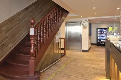 a spiral staircase in a lobby with a elevator at XO Hotel Inner in Amsterdam