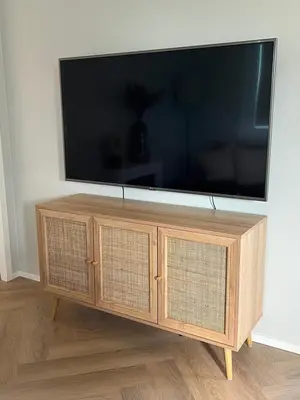 a flat screen tv on top of a wooden entertainment center at NEW - Waterhouse Linada on a lake near Amsterdam in Vinkeveen
