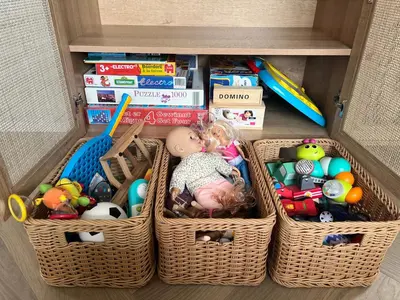 a drawer with baskets filled with toys and books at NEW - Waterhouse Linada on a lake near Amsterdam in Vinkeveen