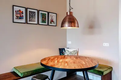 a table and chairs in a room with a lamp at Luxurious Family Home Amstelveen in Amstelveen