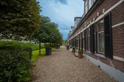 a walkway next to a brick building with windows at Luxurious Family Home Amstelveen in Amstelveen