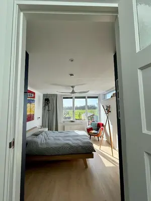 a bedroom with a bed and a window at Luxurious Family Home Amstelveen in Amstelveen
