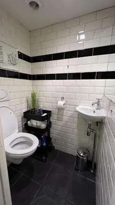 a bathroom with a toilet and a sink at Seastreet Robert in Zandvoort