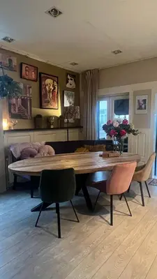 a living room with a large wooden table and chairs at Seastreet Robert in Zandvoort