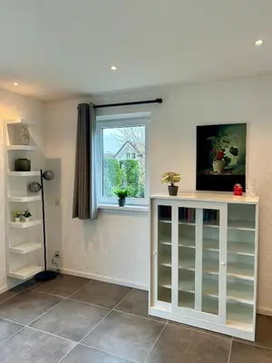 a living room with a window and a shelf at Chateau Noordwijk in Noordwijk