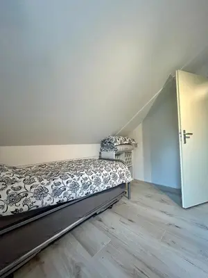 an empty bedroom with a bed in a room at Chateau Noordwijk in Noordwijk
