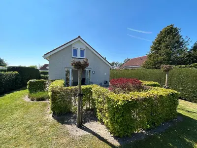 a house with a cross in the yard at Chateau Noordwijk in Noordwijk