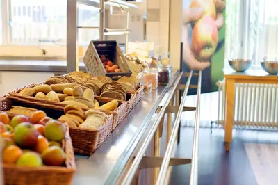 a counter with baskets of apples and other fruits at Stayokay Hostel Haarlem in Haarlem