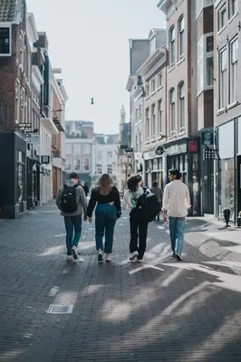 a group of people walking down a city street at Stayokay Hostel Haarlem in Haarlem