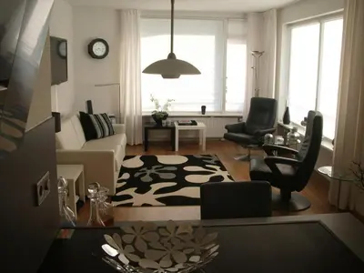 a living room with a couch and a table at Sterflat 87 in Egmond aan Zee