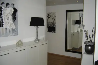 a living room with a lamp and a mirror at Sterflat 87 in Egmond aan Zee