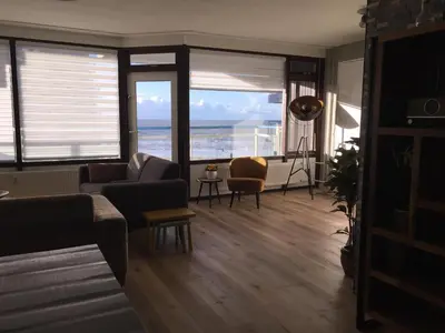 a living room with a view of the ocean at Sterflat 103 in Egmond aan Zee