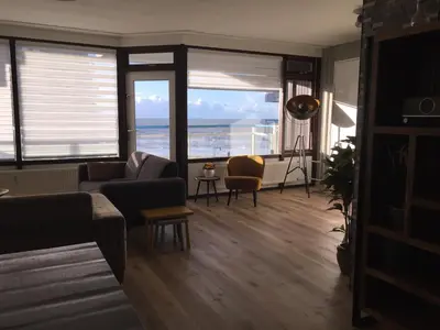 a living room with a view of the ocean at Sterflat 103 in Egmond aan Zee