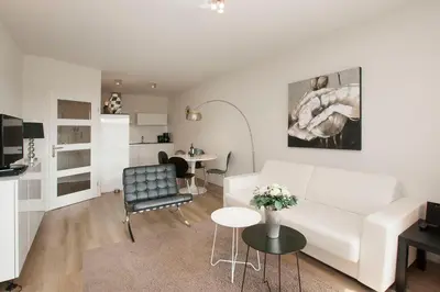 a living room with a white couch and a table at Sterflat 107 in Egmond aan Zee