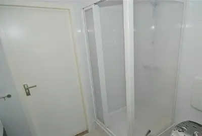a white shower in a bathroom with a toilet at Sterflat 129 in Egmond aan Zee
