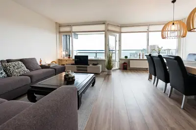 a living room with a couch and a table at Sterflat 147 in Egmond aan Zee