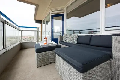 a living room with a couch and a table at Sterflat 147 in Egmond aan Zee
