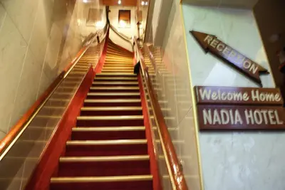 a staircase in a building with a sign for a hotel at Nadia Hotel in Amsterdam