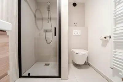a bathroom with a shower and a toilet at Studio Becke, with private parking in Zandvoort