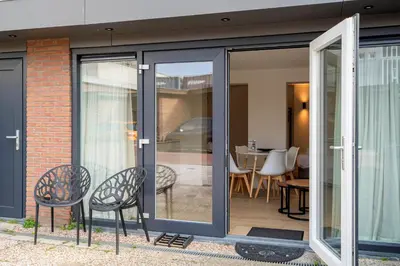 an extension to a house with sliding glass doors at Studio Becke, with private parking in Zandvoort