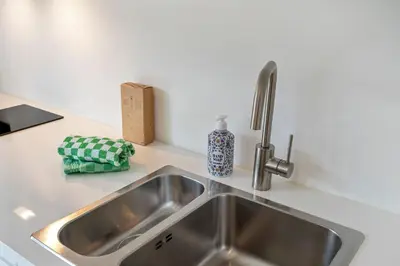 a stainless steel kitchen sink in a kitchen at Studio Becke, with private parking in Zandvoort