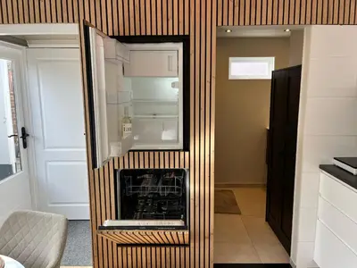 a refrigerator with its door open in a kitchen at Have a nice stay! - Huisje bij Zee gratis parkeren in Noordwijk aan Zee