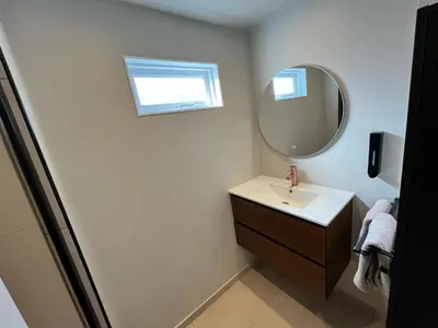 a bathroom with a sink and a mirror at Have a nice stay! - Huisje bij Zee gratis parkeren in Noordwijk aan Zee
