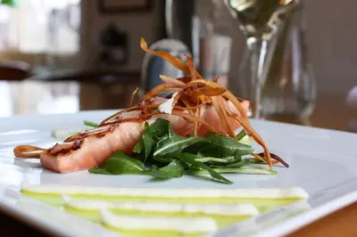a seafood dish on a white plate on a table at Hotel & Restaurant De Fortuna in Edam