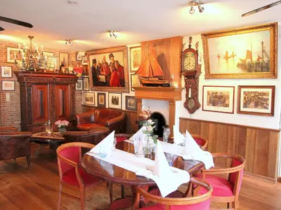a dining room with a table and a fireplace at Hotel & Restaurant De Fortuna in Edam