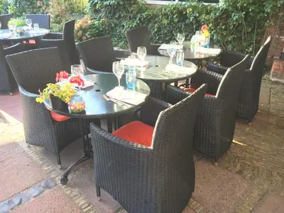 a group of tables and chairs at a restaurant at Hotel & Restaurant De Fortuna in Edam