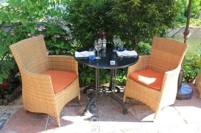 a table with two chairs and a table with wine glasses at Hotel & Restaurant De Fortuna in Edam
