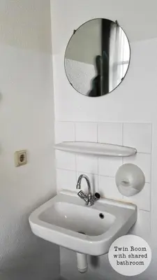 a bathroom with a sink and a mirror on the wall at Rembrandt Square Hotel in Amsterdam