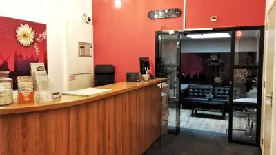 a bar in a restaurant with red walls at Rembrandt Square Hotel in Amsterdam