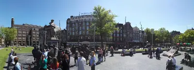 a crowd of people standing around in a city at Rembrandt Square Hotel in Amsterdam