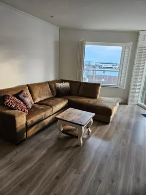 a living room with a couch and a coffee table at Sterflat 157 in Egmond aan Zee