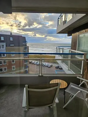 a balcony with a view of the ocean at Sterflat 157 in Egmond aan Zee